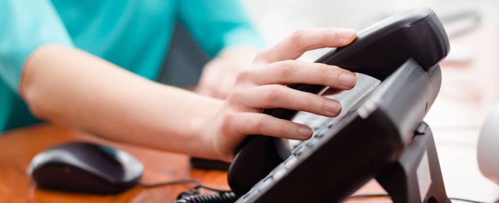 Business telephone handset on a desk